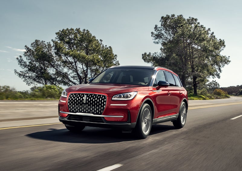 A 2024 Lincoln Corsair® SUV is shown being driven on a country road. | Johnson Sewell Lincoln in Marble Falls TX